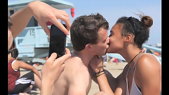 Beautiful Black Girl Gives A Passionate Kiss To White Boy At The Beach