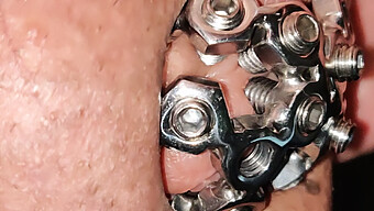 Intense Close-Up Of Chastity Cage Screw